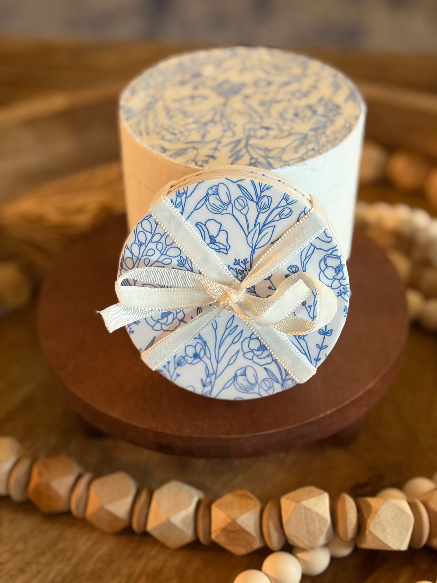 Round keepsake box with a decoupaged floral lid tied closed with a soft silk ribbon.
